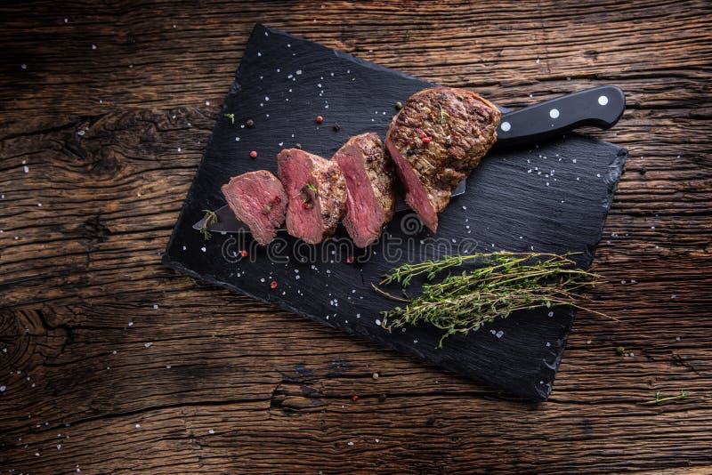 Beef Steak. Roasted Beef Steak with Salt Pepper Thyme on Rustic Wooden