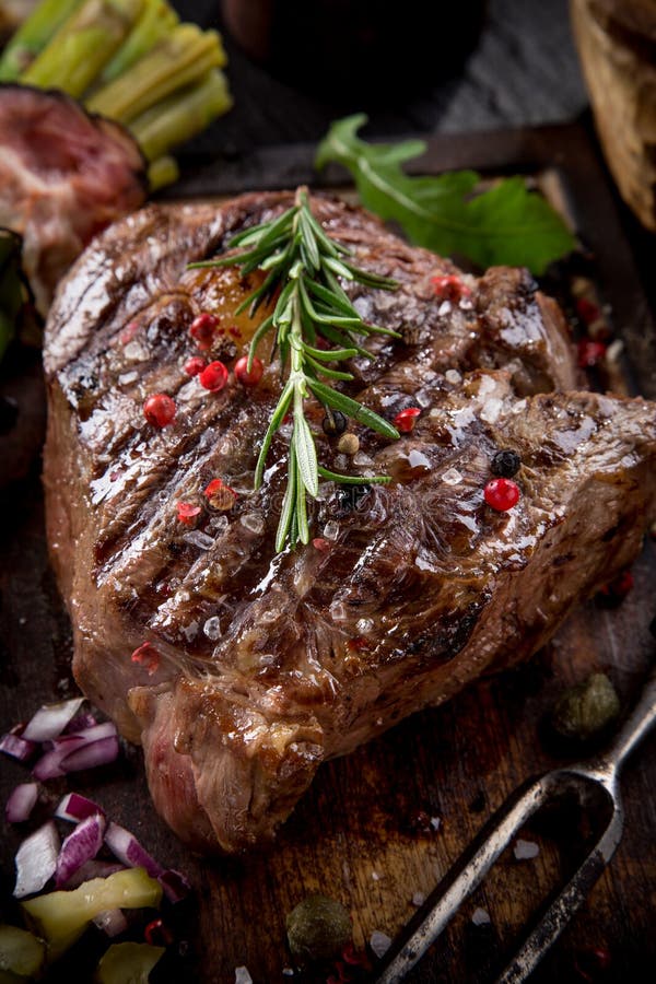 Beef steak on wooden table stock image. Image of closeup - 45272627