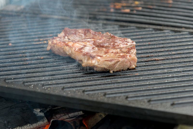 Beef steaks on the grill stock photo. Image of grilled 73036678