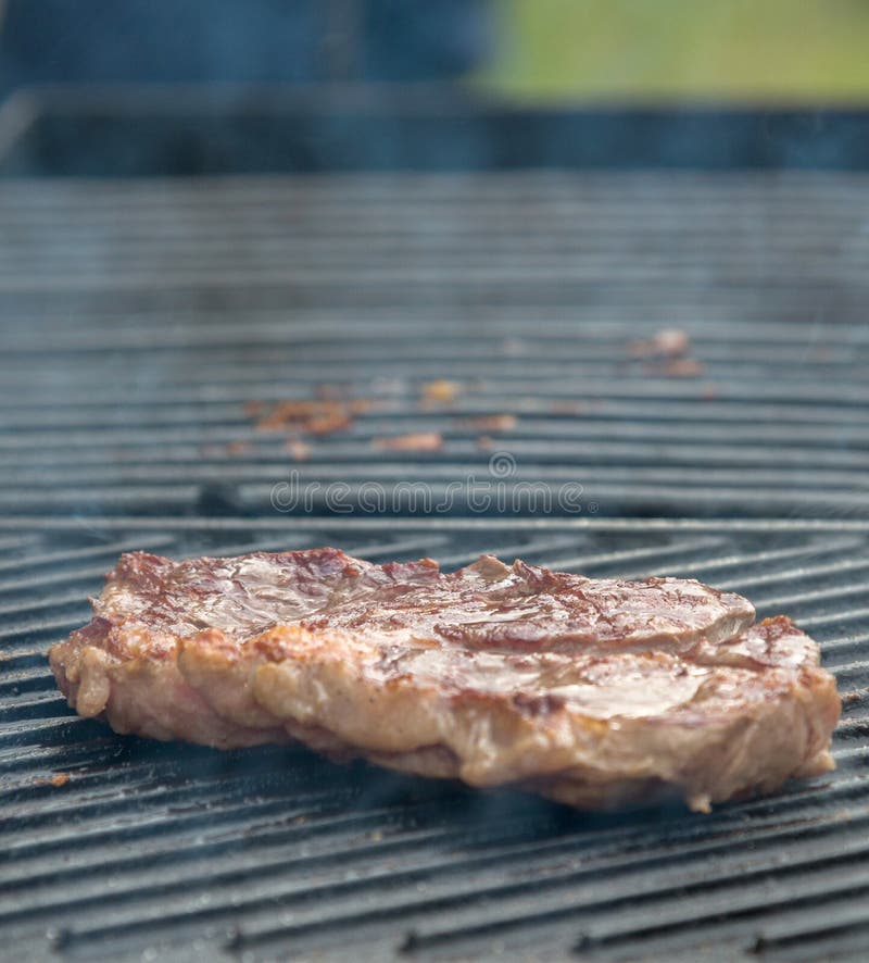 Beef steaks on the grill stock image. Image of grilled 73037505