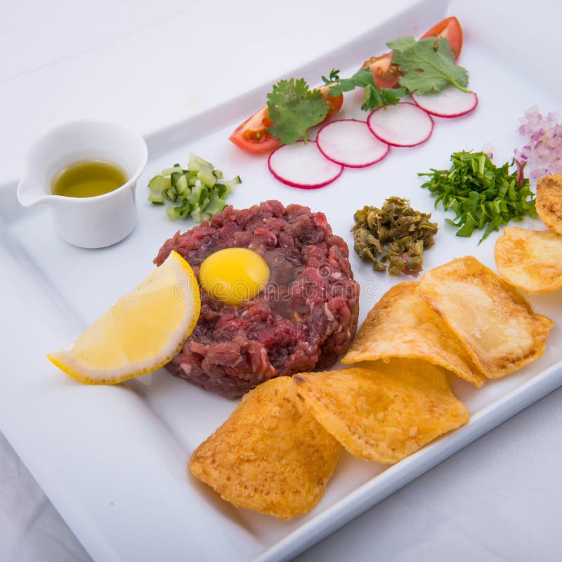 Beef tartar with potato chips and olive oil