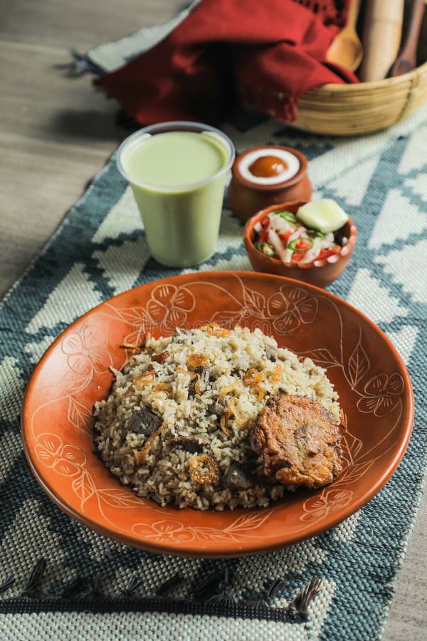 Beef Tehari Combo with shami kabab tikki, salad, borhani and baked gulab jamun served in dish isolated on mat top view of indian and bangladeshi food.