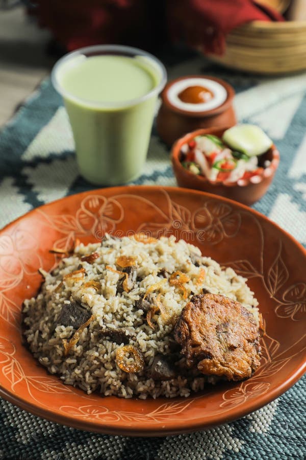 Beef Tehari Combo with shami kabab tikki, salad, borhani and baked gulab jamun served in dish isolated on mat top view of indian and bangladeshi food.