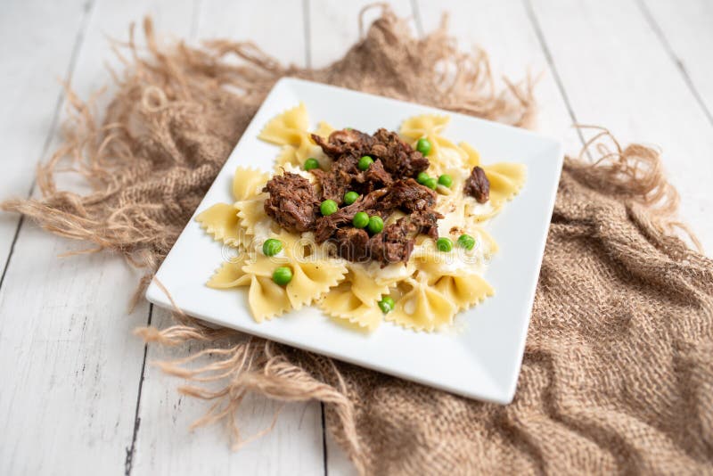Beef Tips Over Bow Tie Pasta and Alfredo Sauce Stock Photo Image of