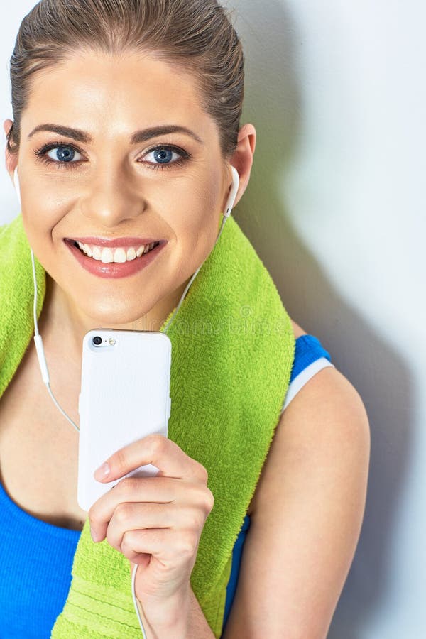 Beeg toothy smile. Close up face portrait of teeth smile woman with towel on neck. listening music on headphones