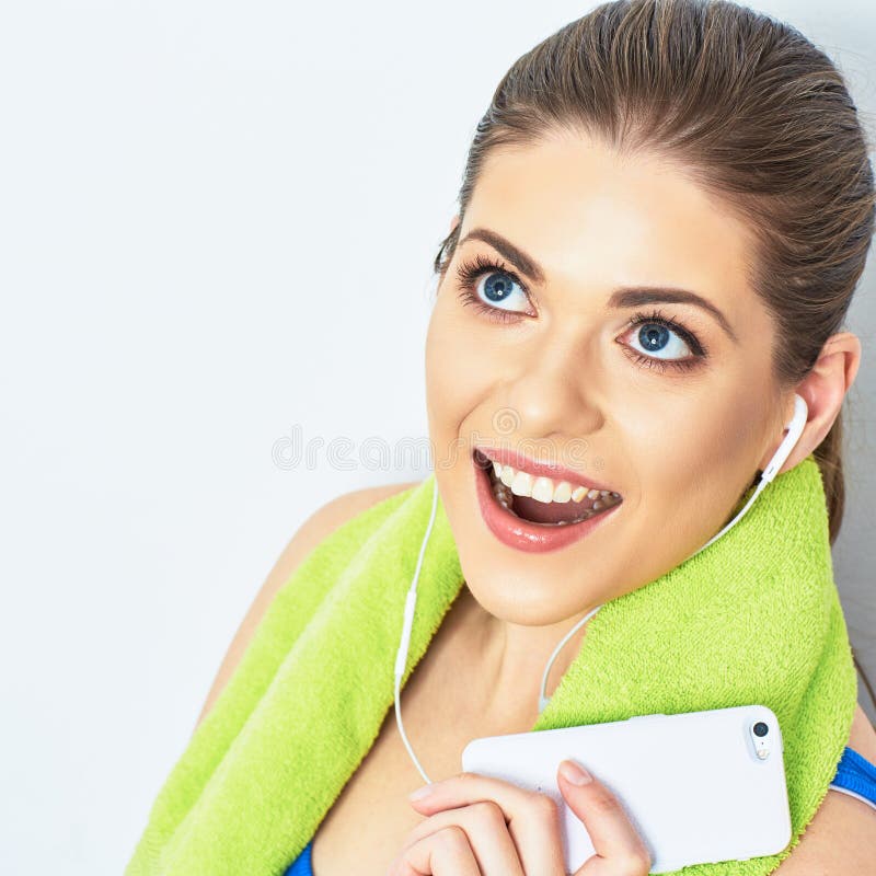 Beeg toothy smile. Close up face portrait of teeth smile woman with towel on neck. listening music on headphones