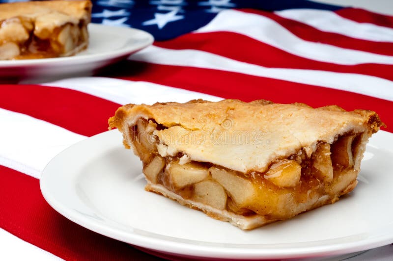 Shallow focus horizontal image of 2 pcs of apple pie on the American flag. Shallow focus horizontal image of 2 pcs of apple pie on the American flag