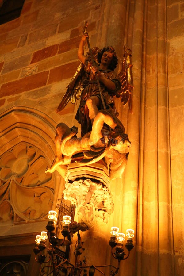 The sculpture from St Vitus Cathedral in Prague, Czech republic.Angel vs the devil (satan),This is adapted from a story from the bible, beat the devil angel. The sculpture from St Vitus Cathedral in Prague, Czech republic.Angel vs the devil (satan),This is adapted from a story from the bible, beat the devil angel.