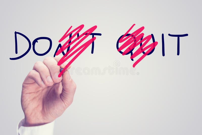 Dont Quit - Do It, conceptual image with a man scrubbing through letters in the words Dont Quit converting them to Do It with a red pen in a motivational message of hope and perseverance. Dont Quit - Do It, conceptual image with a man scrubbing through letters in the words Dont Quit converting them to Do It with a red pen in a motivational message of hope and perseverance.