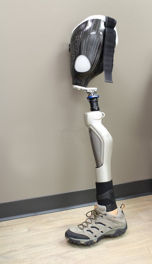 Leg prosthesis with shoe, leaning against a wall. Leg prosthesis with shoe, leaning against a wall