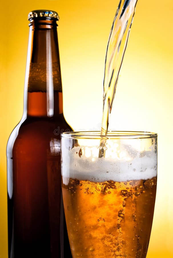 Beer Being Poured in Glass and Bottle stock images Beer Being Poured in Glass and Bottle stock images