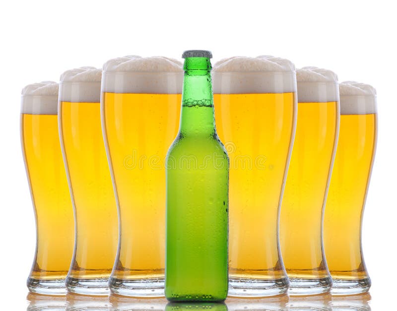 A green beer bottle standing in front of six cold frosty glasses with foamy tops. Horizontal format over white with reflections. A green beer bottle standing in front of six cold frosty glasses with foamy tops. Horizontal format over white with reflections.