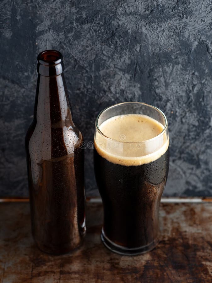 Beer Bottle and a Full Glass of Craft Beer Porter Stock Photo Image