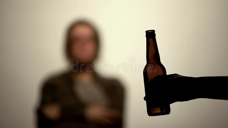 Beer bottle in male hand white background, alcohol offer, rehabilitation center royalty free stock photography Beer bottle in male hand white background, alcohol offer, rehabilitation center royalty free stock photography