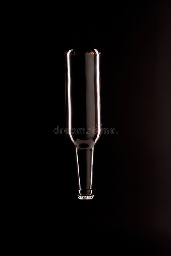 Beer Bottle Upside Down Isolated on Black Background Stock Image