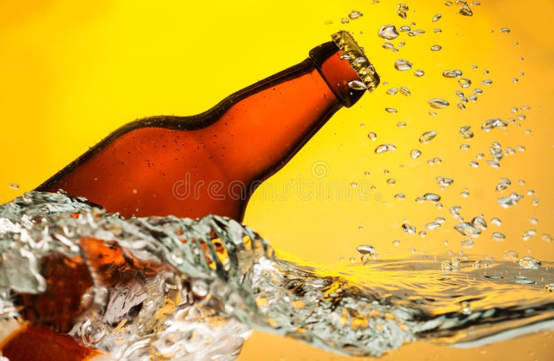 Beer bottle in water stock photo. Image of yellow, drop 36416388