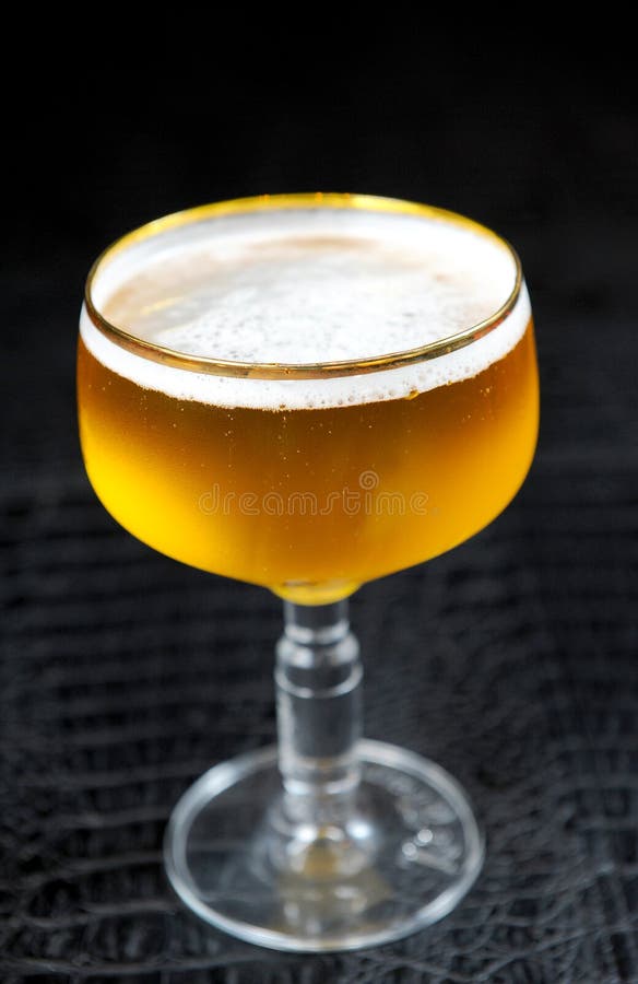 Beer into glass on a black stock image. Image of bubbles 24690857