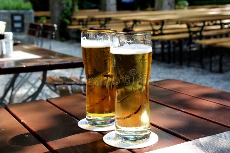 Beer glasses on the table in garden.