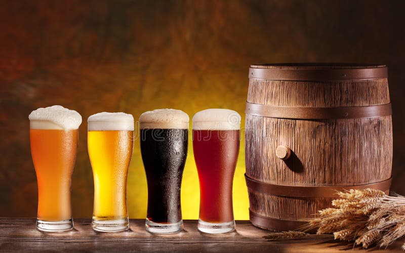 Beer glasses with a wooden barrel. royalty free stock photography