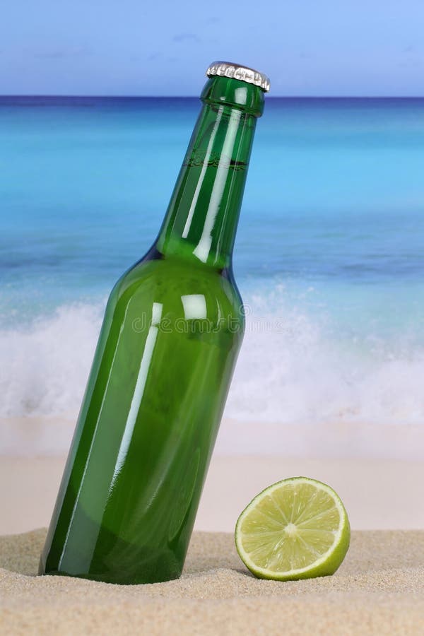 Beer in Green Bottle on the Beach and Sea Stock Image Image of limes