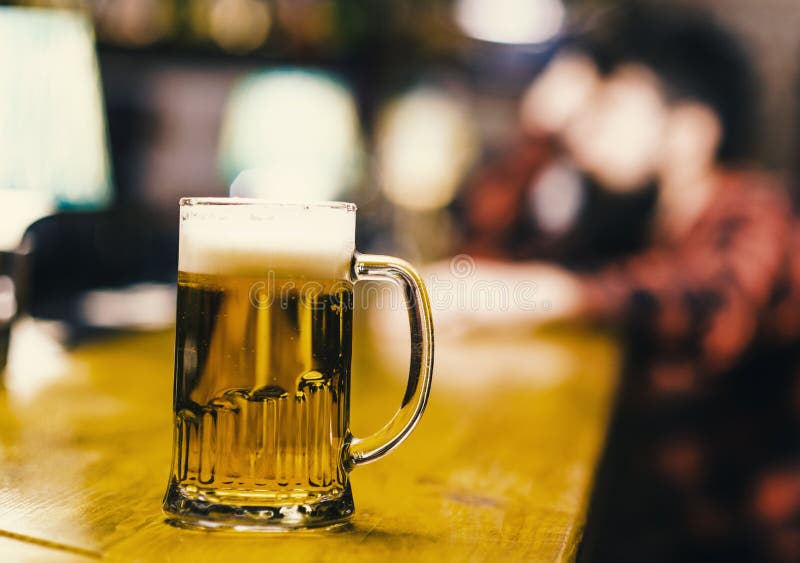 Beer in the grocery. Glass with fresh lager draft beer with foam, close up. Glass filled with cold tasty beer in pub royalty free stock image Beer in the grocery. Glass with fresh lager draft beer with foam, close up. Glass filled with cold tasty beer in pub royalty free stock image