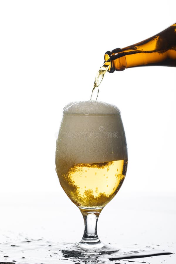 Pouring from Bottle into Glass on Stock Photo Image of stream, foam