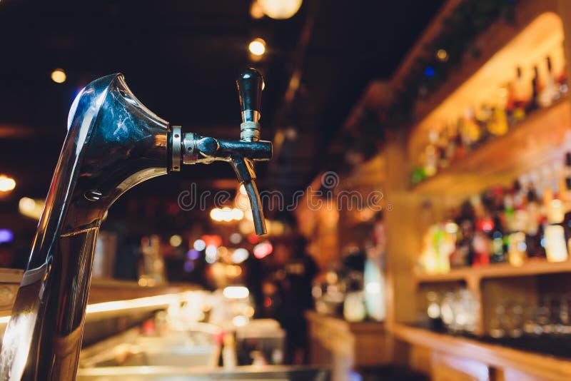 Beer Tap Pours Draught Lager Beer Serving in a Restaurant or Pub. Stock