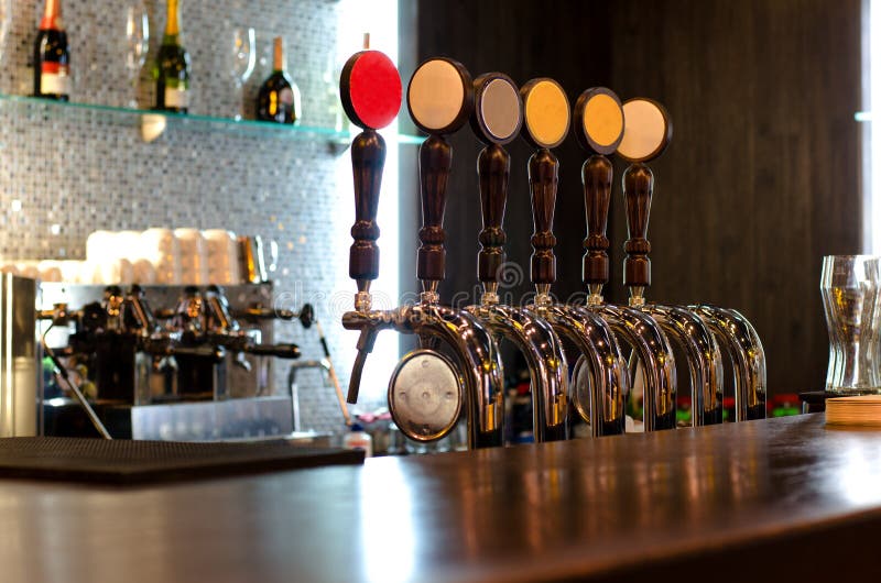 Beer taps behind a bar counter