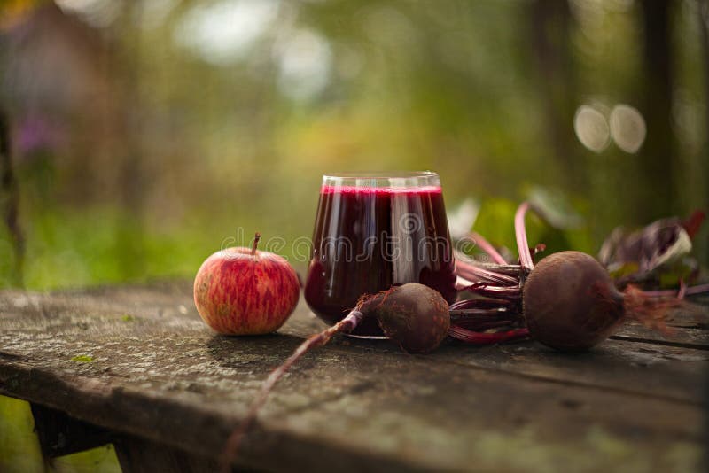 Beet-apple juice in glass on table