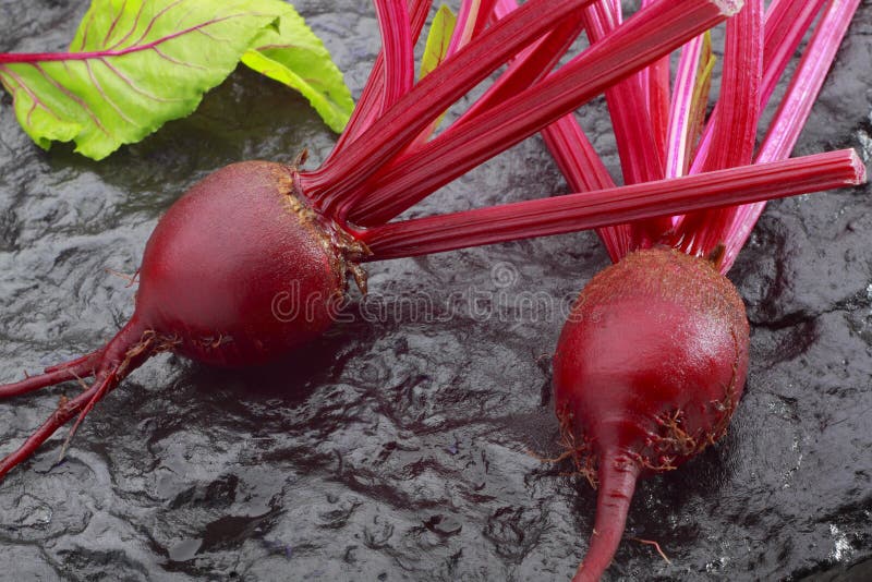 Beetroot on black painted stone stock photo