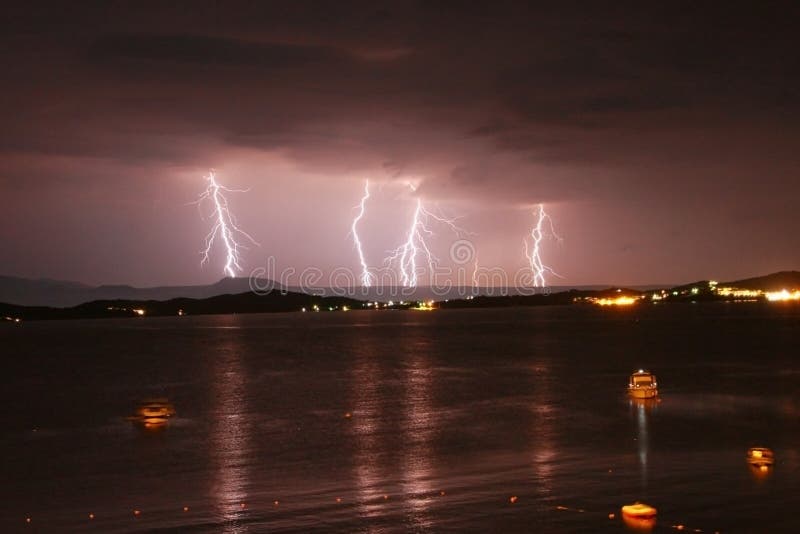 Beginning of a storm in a sea with lightnings in purple sky. stock photography Beginning of a storm in a sea with lightnings in purple sky. stock photography