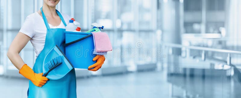 The concept of cleaning services. Cleaning lady with detergent and brush on a blurry background. The concept of cleaning services. Cleaning lady with detergent and brush on a blurry background