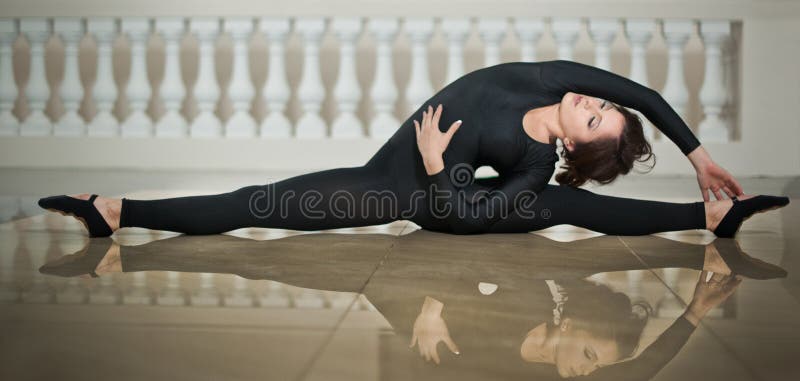 Graceful ballerina doing the splits on the marble floor. Gorgeous ballet dancer performing a split on glossy floor. Short hair young brunette in tight fit ballet outfit making her exercises. Graceful ballerina doing the splits on the marble floor. Gorgeous ballet dancer performing a split on glossy floor. Short hair young brunette in tight fit ballet outfit making her exercises.