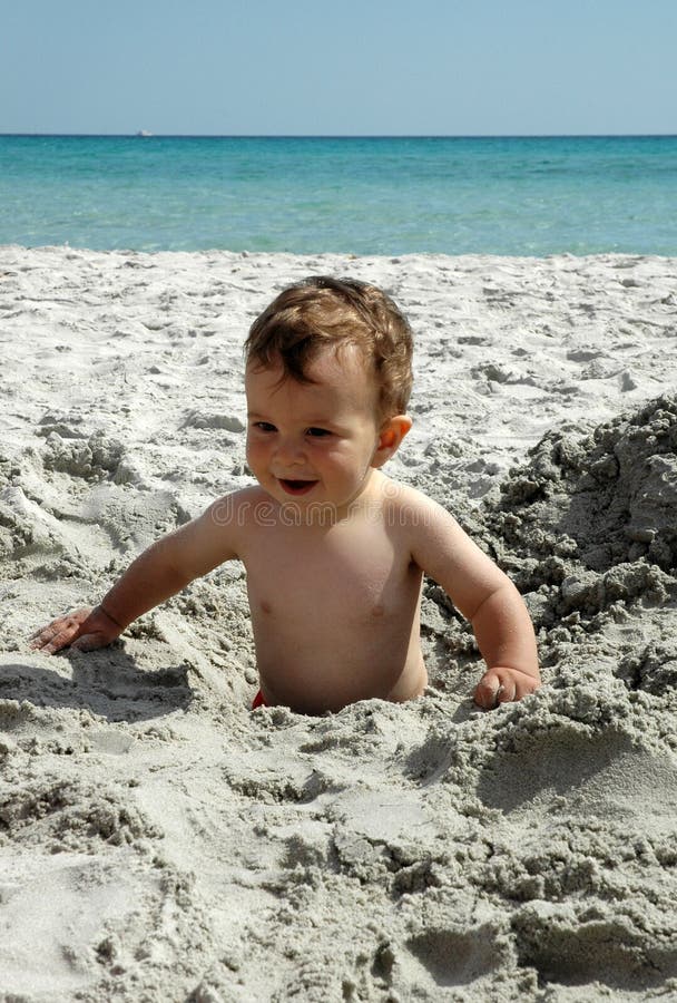 A baby on sand, the baby is one year old. A baby on sand, the baby is one year old
