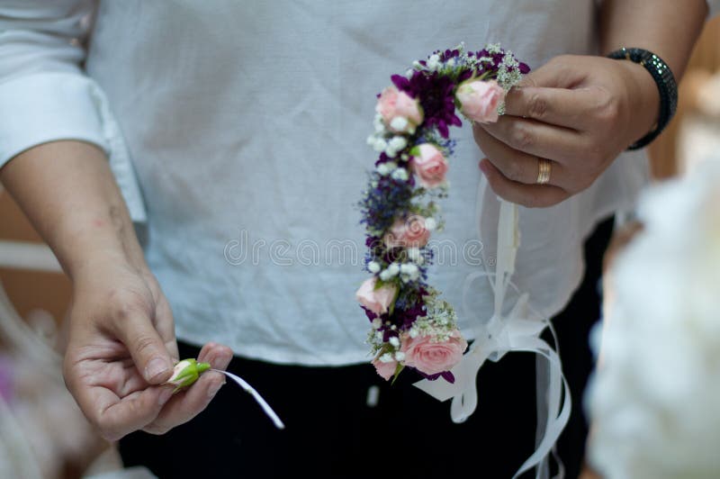 Girl Making a Beautiful Wedding Flower Crown with Pink Roses