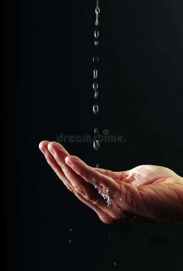 Woman's hand catching precious drops of water, against black. Woman's hand catching precious drops of water, against black.