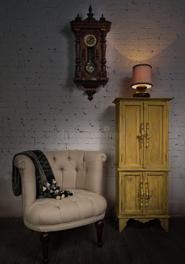 Beige armchair, yellow cupboard, pendulum clock and illuminated table lamp stock image Beige armchair, yellow cupboard, pendulum clock and illuminated table lamp stock image