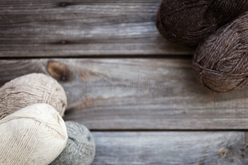 Beige, brown, gray and white balls of yarn. Wooden background royalty free stock images Beige, brown, gray and white balls of yarn. Wooden background royalty free stock images