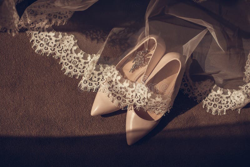 shoes elegant leather women`s shoes on a wooden background light glossy heel shoes Bride shoes and a small bouquet stock photo shoes elegant leather women`s shoes on a wooden background light glossy heel shoes Bride shoes and a small bouquet stock photo