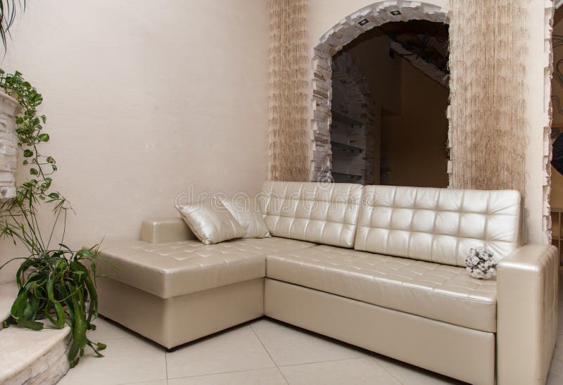 Beige living room with beige couch and wallpaper