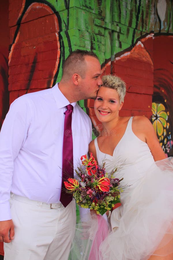 Groom kissing the bride to show her his love. Groom kissing the bride to show her his love.