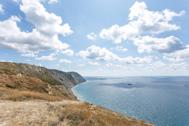 Beautiful landscape of high coast, blue sea and fluffy clouds on a sunny summer day. The Black Sea coast. Anapa. Beautiful landscape of high coast, blue sea and fluffy clouds on a sunny summer day. The Black Sea coast. Anapa.