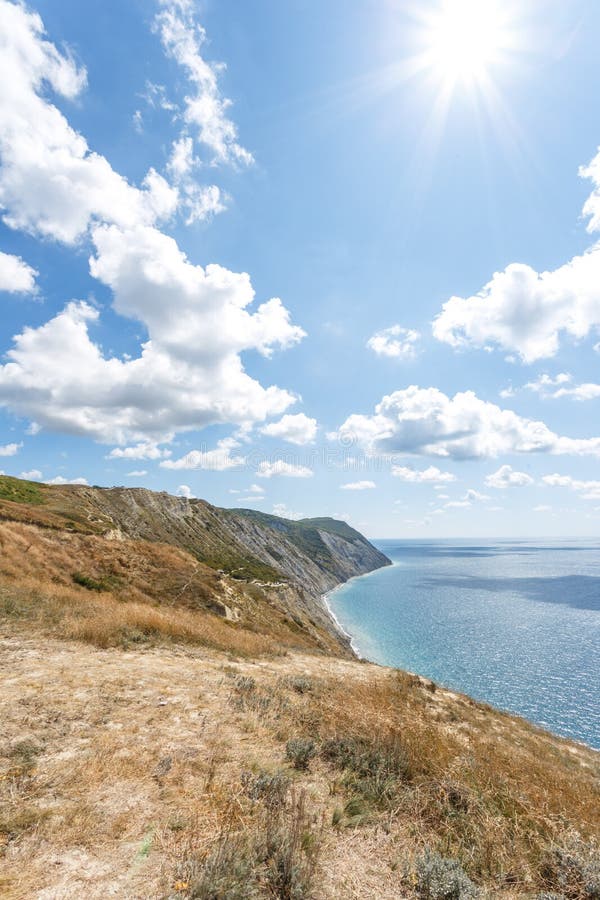 Beautiful landscape of high coast, blue sea and fluffy clouds on a sunny summer day. The Black Sea coast. Anapa. Beautiful landscape of high coast, blue sea and fluffy clouds on a sunny summer day. The Black Sea coast. Anapa.