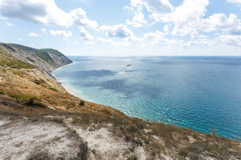 Beautiful landscape of high coast, blue sea and fluffy clouds on a sunny summer day. The Black Sea coast. Anapa. Beautiful landscape of high coast, blue sea and fluffy clouds on a sunny summer day. The Black Sea coast. Anapa.