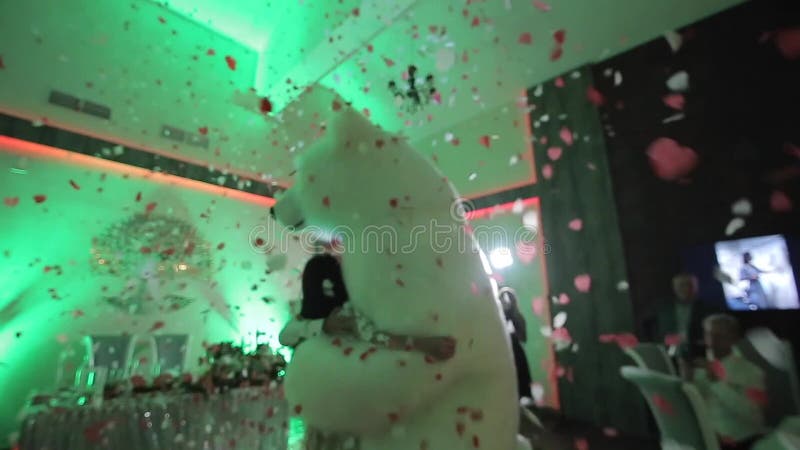 Belarus, Minsk - January 15, 2019: Wedding party. Man in a big polar bear costume is dancing at a wedding with the bride