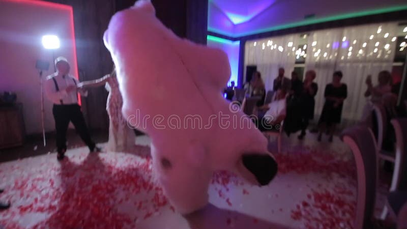 Belarus, Minsk - January 15, 2019: Wedding party. Man in a big polar bear costume is dancing at a wedding with the bride