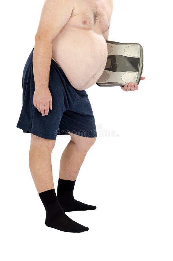 Overweight man in the black socks stands with weight scales in left hand on a white background. Overweight man in the black socks stands with weight scales in left hand on a white background