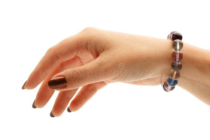 Beautiful bracelet made of colorful fluorite round beads on elegant female hand isolated on white background. Close up. Beautiful bracelet made of colorful fluorite round beads on elegant female hand isolated on white background. Close up.