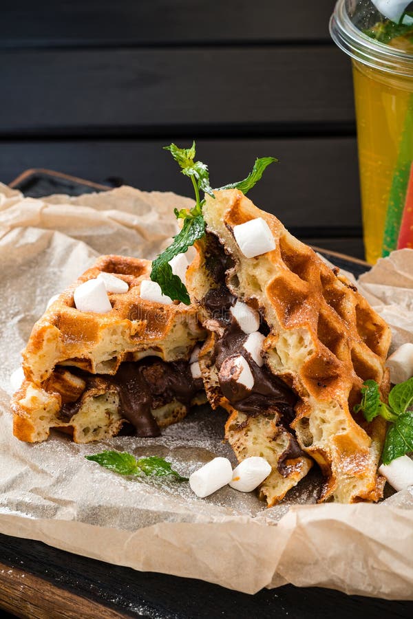 Belgian Waffle with Marshmallows and Chocolate on Dark Background Stock