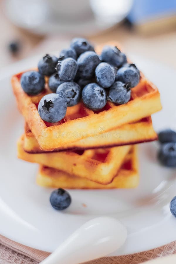 Belgian Waffles with Blueberries on the Light Wooden Table. Healthy Breakfast Stock Photo